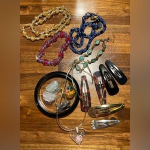 Assortment of plastic jewelry, beaded jewelry and barrettes.